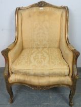 An antique French giltwood armchair in the Louis XV taste, with acanthus carved cornice, upholstered