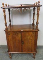 A Victorian figured walnut two-tier Canterbury whatnot, having turned finials and brass gallery