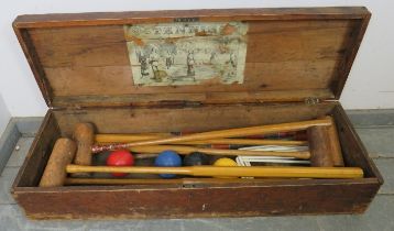 An antique boxed croquet set, comprising five mallets, four balls and nine hoops. Box H22cm W105cm