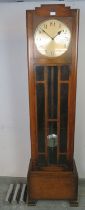 An Art Deco Period oak cased Westminster chiming longcase clock, having a three weight driven