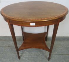 An Edwardian mahogany oval occasional table, crossbanded and strung with satinwood and ebony, on