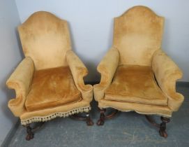 A pair of 19th century armchairs in the George I taste, having camel backs, scrolled arms and shaped