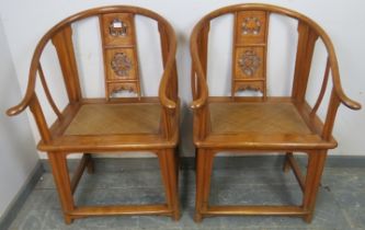 A pair of antique elm Chinese horseshoe chairs, having well-carved and pierced back splats above