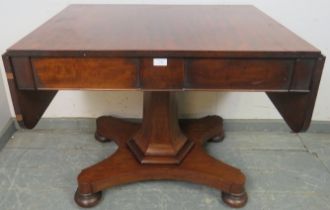 A 19th century mahogany sofa table, housing two blind drawers, on a tapering hexagonal column with