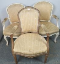 A pair of antique French open-sided armchairs in the Louis XV taste, painted white and distressed,