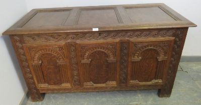 A good 17th century Charles I oak panelled chest, having a carved frieze, arcaded front panels and