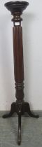 A Victorian mahogany jardinière/plant stand, the fluted and carved column on splayed tripod