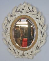 A small 19th century parcel gilt bevelled oval wall mirror, within a carved and pierced surround