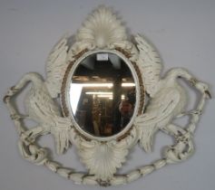 An 18th century Georgian oval mirror, within an ornately carved wooden surround having a shell