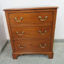 A Georgian mahogany chest of small proportions, housing three graduated cock-beaded drawers with