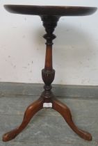 A Georgian mahogany wine table, the dished top having central roundel with batwing inlay, on a