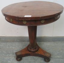 A Regency Period mahogany occasional table, having gilt metal mounts depicting foliate roundels