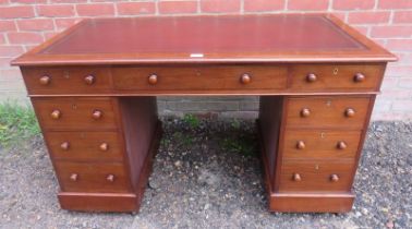 A 19th century walnut pedestal desk, having inset gilt tooled burgundy leather surface, housing a