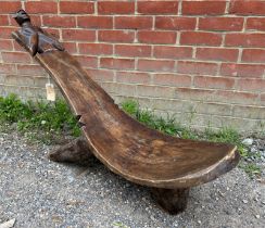 Tribal Art: An African carved wood easy chair, Lobi people, Ivory Coast. The head of the chair