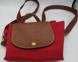 A Longchamp red canvas Le Pliage backpack bag. Condition report: Good condition.