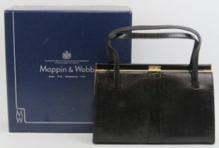 A Mappin & Webb black lizard skin handbag. With gilt metal mounts and clasp, the interior with a zip