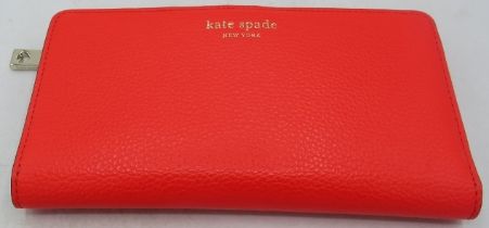 A Kate Spade red wallet/purse. Condition report: Good condition.