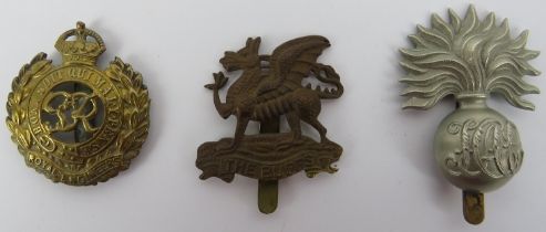 Militaria: Three British Military brass cap badges. Comprising a Royal Engineers badge, a Royal East