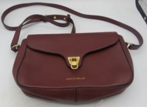 A Coccinelle dark red leather crossbody bag. (Italian). Condition report: Good condition.