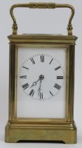 A French gilt brass cased carriage clock retailed by J W Benson of London. With an enamelled white