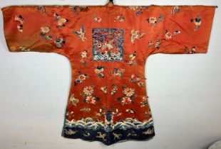 A Chinese kesi and Peking knot silk embroidered red robe, probably late 18th/early 19th century.