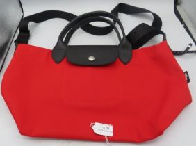 A Longchamp bright red canvas bag with shoulder strap. Condition report: Good condition.