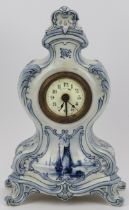 A German Delft style ceramic mantle clock. French brass movement. Identical in style to German