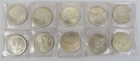 Ten Canadian silver dollar coins, dated 1965. (10 items) Condition report: Light age related wear.