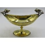 A boat shaped silver gilt dish on a pedestal base with a bird on each end, Birmingham 1920. Engraved