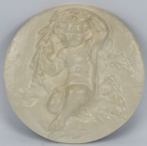 A Victorian cast iron wall plaque. Decorated with a putti amongst foliage in relief. 27 cm diameter.