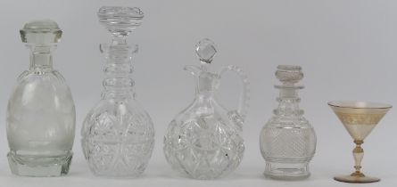 Four clear glass decanters and a cocktail glass. Comprising three cut glass decanters, a decanter