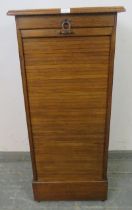 An early 20th century oak tambour front pedestal cabinet, containing drawers, with key, pedestal