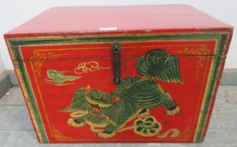 An Eastern chinoiserie decorated red lacquered storage box, 20th century, 52cm wide x 35cm high x