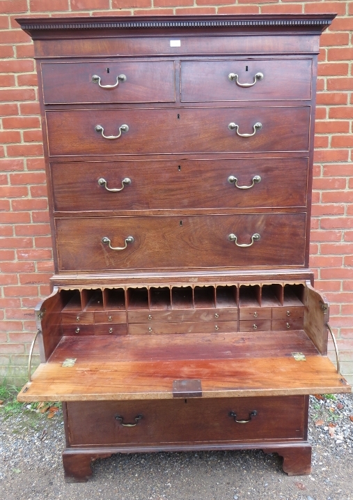 A George III mahogany secretaire chest on chest, having a dentil cornice above two short over