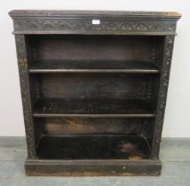 A 19th century carved oak open-front low bookcase in the Flemish taste, 2 adjustable shelves, plinth