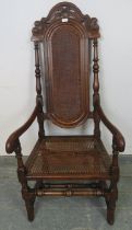 An antique and later oak open-sided armchair in the William & Mary style, with caned seat and back