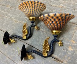 A pair of stylish decorative wall lights, gilded and blue finished cast metal winged serpents