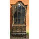 A 19th century Continental ebonised display cabinet, having chinoiserie motifs with gold accents,