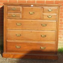 A turn of the century walnut bedroom chest, the central hat drawer flanked by four short drawers,