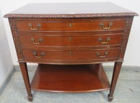 An Edwardian oak bow front cutlery table in a George III taste with rope-twist carved borders and