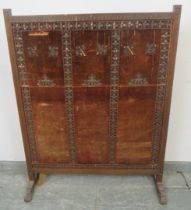 A large 19th century mahogany firescreen, with chip carved frieze, the antique velvet panel with