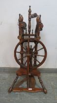 A vintage fruitwood spinning wheel in the 18th century style, 45cm high.