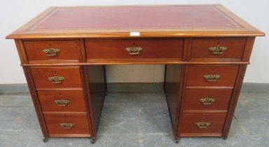 An Edwardian mahogany child's pedestal desk, inset red leather top above configuration of 9
