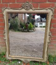 A decorative period-style wall mirror, 20th century, relief moulded decoration, gilt and paint