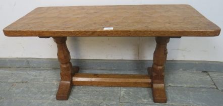 A vintage carved oak low side table by Robert Thompson, the 'Mouseman', the adzed top on tapering