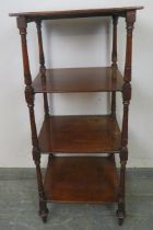 A 19th century mahogany four-tier whatnot, with turned uprights, raised on casters. H114cm W51cm (