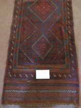 A Meshwani runner, repeat central pattern on a burgundy ground. Good condition. 246cm x 58cm.