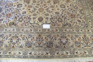 A central Persian Kashan carpet, busy floral pattern on cream ground. Condition report: Very good