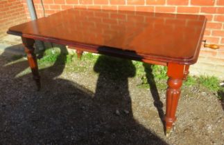 A Victorian mahogany wind-out extending dining table, with additional leaf, on tapering fluted