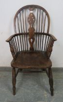 An early 20th century elm & beech wheel-back Windsor armchair.